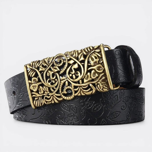 Le monde de la ceinture black leather belt with ornate gold buckle and embossed floral pattern.