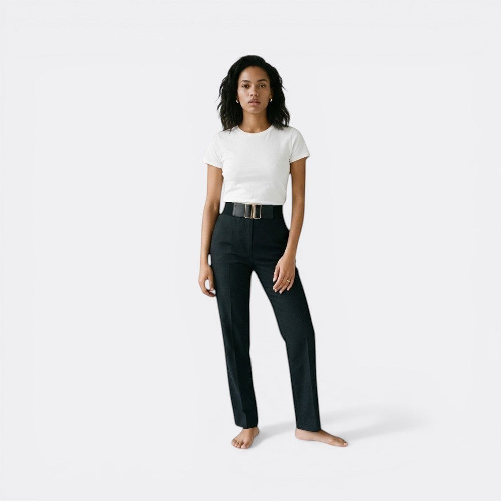 Le monde de la ceinture black leather wide belt with gold buckle cinching high-waisted trousers