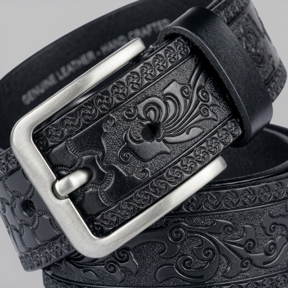 Le Monde de la Ceinture black genuine leather belt with intricate tribal embossed pattern and silver buckle.
