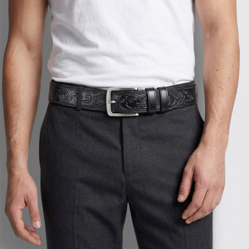 Le Monde de la Ceinture black embossed leather tribal belt with silver buckle.