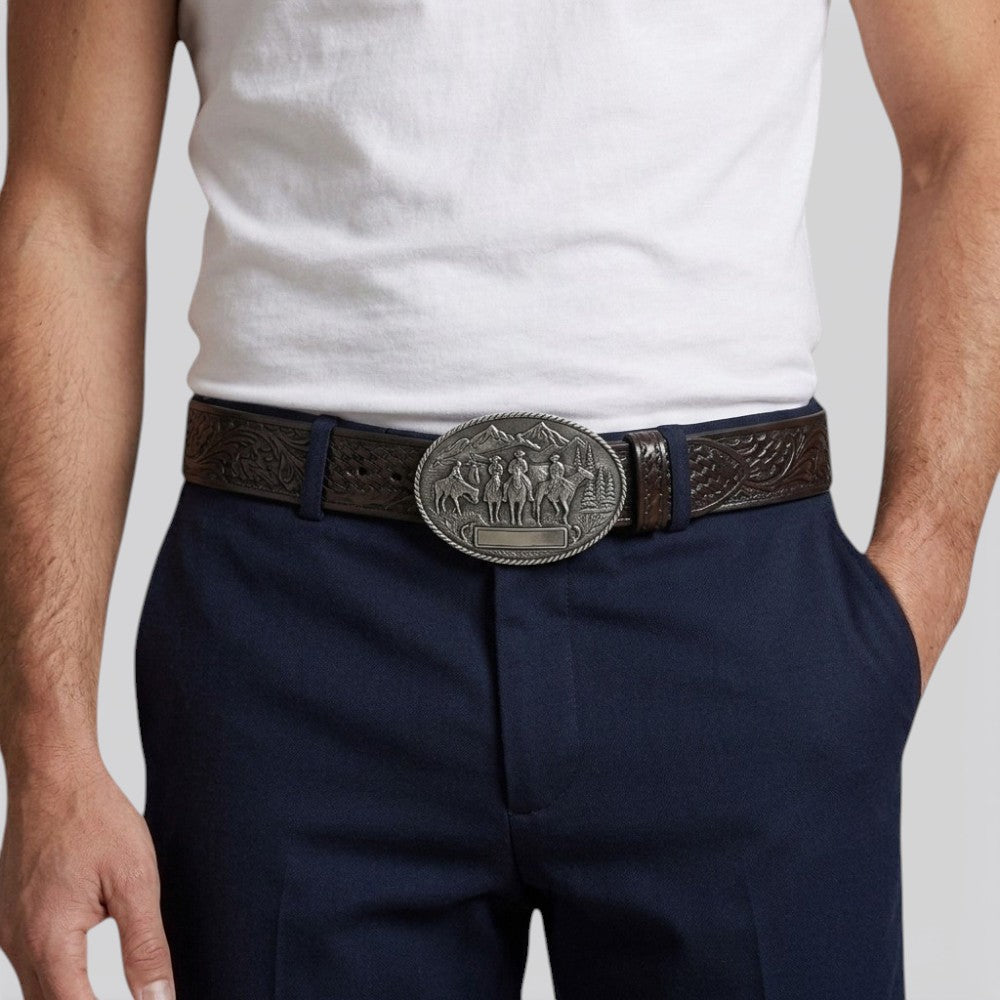 Le monde de la ceinture men's dark brown embossed leather belt with a large oval vintage buckle featuring cowboys on horseback.