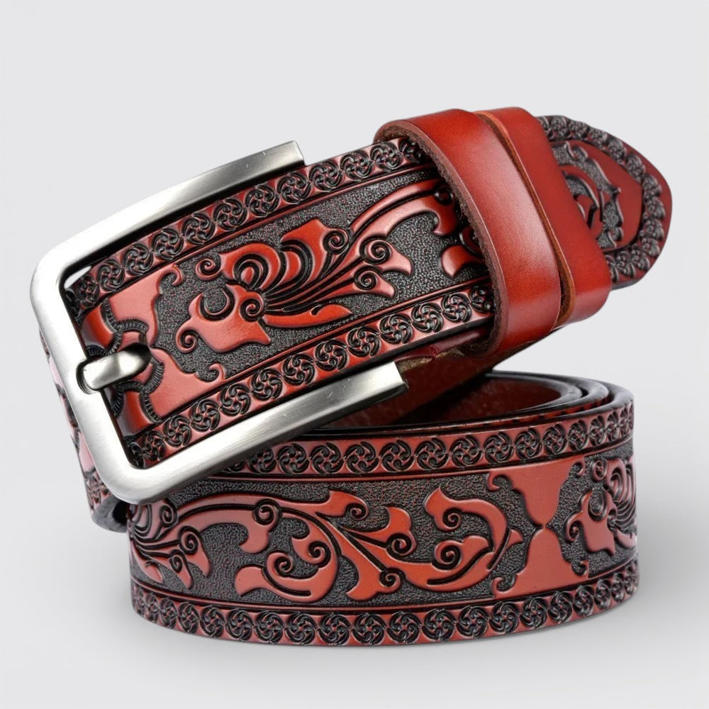 Le monde de la ceinture brown leather belt with intricate tribal embossed pattern and silver buckle.