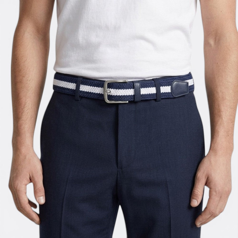 Le monde de la ceinture navy and white striped woven belt with leather details and silver buckle.