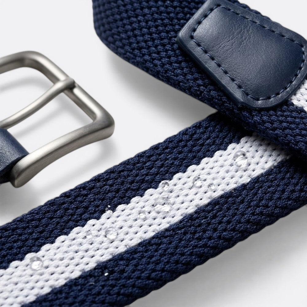 Le monde de la ceinture navy blue and white striped woven belt with leather details and silver buckle.