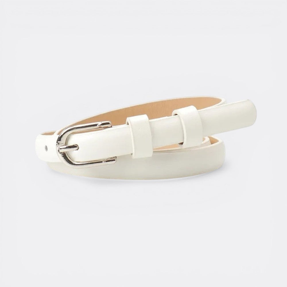 Le monde de la ceinture white leather skinny belt with silver buckle. Adds structure and elegance to dresses, jeans, and suits.